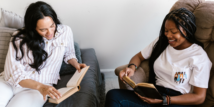 Two sitting with open books.