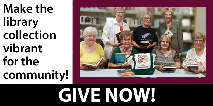 book club group holding their books and beside a book club kit