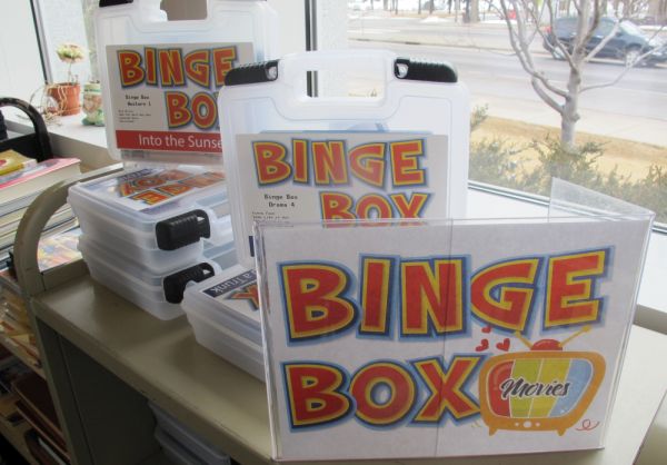 Stacks of plastic Binge Boxes containing a selection of movies