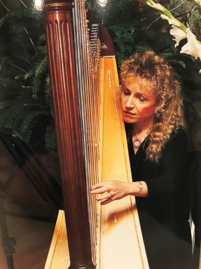 Woman (Chris Ward) playing a harp