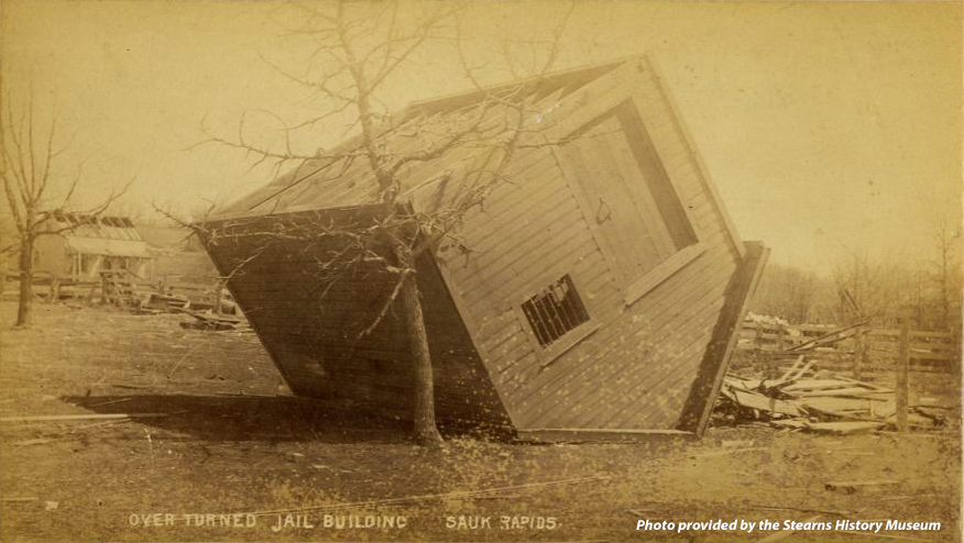 An old, blown over jailhouse sitting on its roof