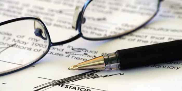 image of glasses and a pen on paper