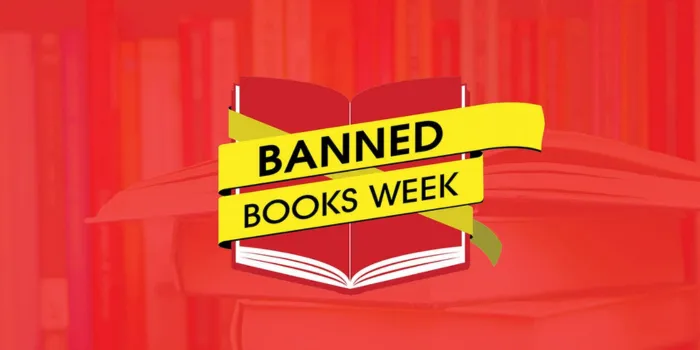 Banned Books Week with yellow tape wrapped around an open red book